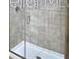 Contemporary shower featuring glass enclosure and light tile at 1588 Leamington Ln, Winter Haven, FL 33884