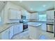 Gourmet kitchen boasts stainless steel appliances, granite countertops and a spacious center island at 1588 Leamington Ln, Winter Haven, FL 33884