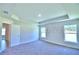 Spacious main bedroom features a tray ceiling, large windows, and neutral carpet at 1588 Leamington Ln, Winter Haven, FL 33884
