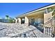 Stone patio with covered sitting area and beautiful water view for relaxing or entertaining outdoors at 1588 Leamington Ln, Winter Haven, FL 33884