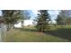 Picture of a well-kept backyard with green grass, trees, and view of other homes at 1610 Reynolds Rd # 239, Lakeland, FL 33801