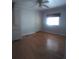 This bedroom offers hardwood floors, a ceiling fan, and a window at 1610 Reynolds Rd # 239, Lakeland, FL 33801