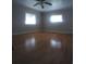 The bedroom has wood floors and a ceiling fan at 1610 Reynolds Rd # 239, Lakeland, FL 33801