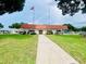 Charming clubhouse with an American flag, red roof, and inviting entrance at 1610 Reynolds Rd # 239, Lakeland, FL 33801