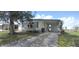 Charming single-story home with a covered parking area and well-maintained front lawn at 1610 Reynolds Rd # 239, Lakeland, FL 33801