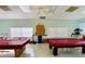 Bright game room featuring two billiard tables, shelving, and ample space for recreation at 1610 Reynolds Rd # 239, Lakeland, FL 33801