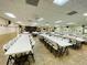 Large meeting room featuring rows of tables and chairs, perfect for gatherings at 1610 Reynolds Rd # 239, Lakeland, FL 33801