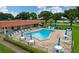 Inviting community pool with ample seating and tables under shady umbrellas at 1610 Reynolds Rd # 239, Lakeland, FL 33801