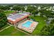 Aerial view of the community pool surrounded by lush greenery and lounge chairs at 1610 Reynolds Rd # 239, Lakeland, FL 33801