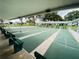 Covered shuffleboard courts with green playing surfaces and comfortable bench seating at 1610 Reynolds Rd # 239, Lakeland, FL 33801