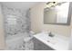 Well-lit bathroom with modern vanity, a toilet, and tub/shower combo featuring decorative tile surround at 1714 2Nd Ne St, Winter Haven, FL 33881