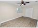 Bedroom with wood-look flooring, natural light from the window, and a double-door closet at 1714 2Nd Ne St, Winter Haven, FL 33881