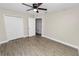 Cozy bedroom with wood-look flooring, closet, and neutral color palette at 1714 2Nd Ne St, Winter Haven, FL 33881