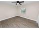 Bedroom features wood-look floors, a ceiling fan, natural light from the window, and neutral colors at 1714 2Nd Ne St, Winter Haven, FL 33881