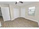 Bedroom with wood-look flooring, closet, natural light from the window, and neutral colors at 1714 2Nd Ne St, Winter Haven, FL 33881