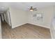 Cozy bedroom featuring new hardwood floors, neutral walls, and a ceiling fan at 1714 2Nd Ne St, Winter Haven, FL 33881