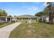 Lovely single-story home with a well-kept lawn, showcasing its curb appeal at 1714 2Nd Ne St, Winter Haven, FL 33881