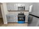 Modern kitchen featuring stainless steel appliances, gray cabinets, and updated countertops at 1714 2Nd Ne St, Winter Haven, FL 33881