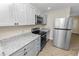 New kitchen featuring stainless steel appliances and granite countertops, well lit at 1714 2Nd Ne St, Winter Haven, FL 33881