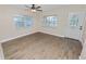 Bright living room with hardwood floors, ceiling fan, and ample natural light at 1714 2Nd Ne St, Winter Haven, FL 33881