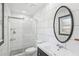 Modern bathroom with a glass-enclosed shower, sleek white tiles, and a stylish vanity at 1722 High Point Dr, Lakeland, FL 33813