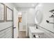 Well-lit bathroom featuring a white vanity, stylish mirror, and modern fixtures at 1722 High Point Dr, Lakeland, FL 33813