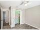 Neutral bedroom with ceiling fan and closet with decorative curtains at 1722 High Point Dr, Lakeland, FL 33813