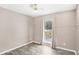 Cozy bedroom featuring wood-look floors and a window with pleasant views at 1722 High Point Dr, Lakeland, FL 33813