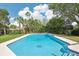 Inviting in-ground swimming pool surrounded by lush landscaping at 1722 High Point Dr, Lakeland, FL 33813