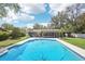 Aerial view of backyard pool and lush greenery at 1722 High Point Dr, Lakeland, FL 33813