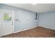 An empty room with laminate flooring and a back door at 1722 High Point Dr, Lakeland, FL 33813