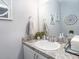 Well-lit half bathroom with vanity, framed mirror, and granite counters at 1728 Burrows Ave, Lakeland, FL 33811