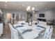 Inviting dining room with hardwood floors, a modern chandelier, and an open view into the living areas at 1728 Burrows Ave, Lakeland, FL 33811