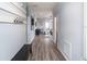 Hallway with hardwood floors, built-in coat rack, and a view into the bright and spacious living areas at 1728 Burrows Ave, Lakeland, FL 33811