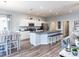 Bright open-concept kitchen and dining area, featuring a large island with bar seating and hardwood floors at 1728 Burrows Ave, Lakeland, FL 33811