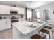 A modern kitchen featuring stainless steel appliances, sleek countertops, and a breakfast bar with stools at 1740 Burrows Ave, Lakeland, FL 33811