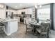 A modern kitchen and eat-in dining area with stainless steel appliances, and gray wood flooring at 1740 Burrows Ave, Lakeland, FL 33811