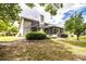 Spacious backyard featuring a screened-in patio with a chimney, and lush greenery at 1842 Pinnacle Dr, Lakeland, FL 33813