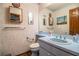 Bathroom with blue vanity, classic fixtures, and wood-look flooring at 1842 Pinnacle Dr, Lakeland, FL 33813