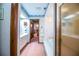 En-suite bathroom with a white vanity, bathtub and view of the carpeted hallway at 1842 Pinnacle Dr, Lakeland, FL 33813