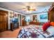 View of a comfortable bedroom with TV, built-in shelves, dresser and a star patterned quilt at 1842 Pinnacle Dr, Lakeland, FL 33813