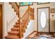 Inviting entryway featuring a staircase, front door with oval window, and colorful rug at 1842 Pinnacle Dr, Lakeland, FL 33813