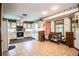 Well-lit kitchen featuring white cabinets, tile floors, and a bay window at 1842 Pinnacle Dr, Lakeland, FL 33813