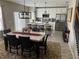 Inviting dining area with a large table, decorative lighting, and a view into the modern kitchen at 1921 Bell Creek Loop, Fruitland Park, FL 34731