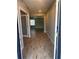 View of the entryway showcasing wood-style tiled flooring, leading to a naturally lit living space at 1921 Bell Creek Loop, Fruitland Park, FL 34731