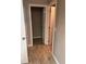 Hallway view with tiled floors leading to a doorway and closet at 1921 Bell Creek Loop, Fruitland Park, FL 34731