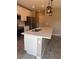 Kitchen island with stainless sink and faucet, white cabinets, and quartz counter tops at 1921 Bell Creek Loop, Fruitland Park, FL 34731