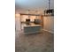 Open kitchen and dining area with modern stainless steel appliances and a quartz island at 1921 Bell Creek Loop, Fruitland Park, FL 34731