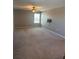 A large living room featuring neutral walls, carpet, and a ceiling fan at 1921 Bell Creek Loop, Fruitland Park, FL 34731