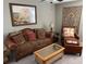 Cozy living room featuring leather furniture, area rug, and tasteful decor creating a comfortable atmosphere at 1921 Bell Creek Loop, Fruitland Park, FL 34731